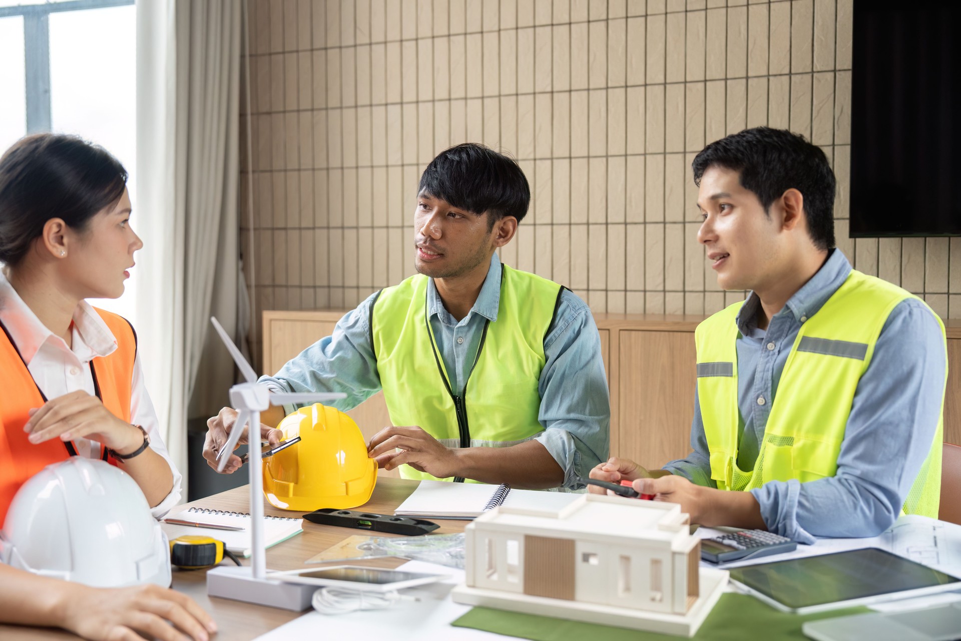 Sustainable Construction Planning. Team of engineers discussing eco-friendly building design.